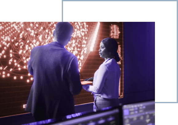 concept photo: man and woman in control room looking at screen with data